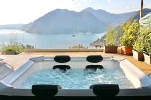 a hot tub with two chairs in it with a view at Villa Turchese - private pool & jacuzzi in Sulzano