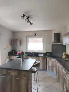 a kitchen with a counter and a window in it at Maison à louer à Allègre in Allègre