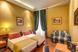 Postel nebo postele na pokoji v ubytování Hotel Impero