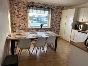 a kitchen with a table and chairs in a room at Amerikavägen 9 in Skellefteå