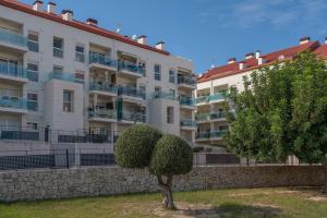 an apartment building with a bush in front of it at Casa2Iberia in Benissa