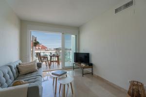 a living room with a couch and a tv at Casa2Iberia in Benissa