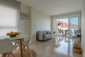 a living room with a couch and a table and chairs at Casa2Iberia in Benissa