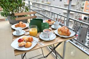 a table with plates of breakfast food on a balcony at Ponte di Tappia Suites in Naples