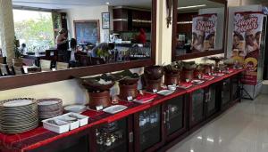 a buffet line with plates and dishes in a restaurant at Zoé’s Paradise Waterfront Hotel in Tuktuk Siadong +26 photos