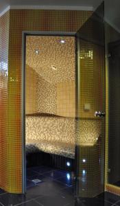 a room with a glass door with a bed in it at Broliu Vila in Druskininkai