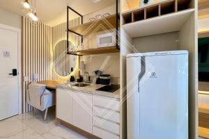 a kitchen with a white refrigerator in a room at Zainalofts7 Perdizes- Ao lado Allianz Parque 212 in Sao Paulo