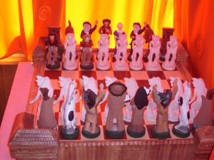 a chessboard made out of chess pieces on a table at Transylvania Cowboy Cottage in Cluj-Napoca
