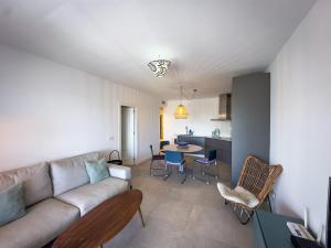 a living room with a couch and a table at Beachfront Apartment Primera Línea 2-04 in Orihuela Costa