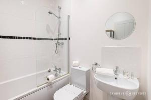 a bathroom with a toilet and a sink and a mirror at Park Views by Grandeur Property in Parkstone +25 photos