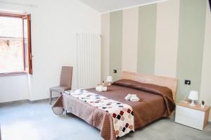 Ένα ή περισσότερα κρεβάτια σε δωμάτιο στο Il Campanile