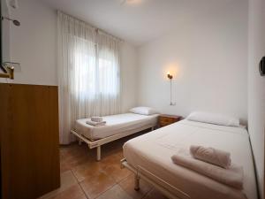 a room with two beds and a window at Beachfront Apartment Primera Línea 2-06 in Orihuela +17 photos
