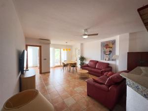 a living room with a couch and a table at Beachfront Apartment Primera Línea 2-06 in Orihuela