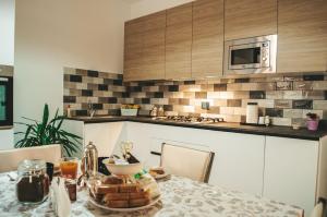 a kitchen with a table with a plate of food on it at Il Campanile in Sutri