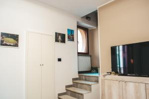 a staircase in a living room with a tv at Il Campanile in Sutri