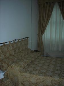 A bed or beds in a room at Hotel Agli Artisti