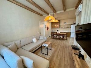 a living room with a couch and a table at Aquaterra, Green Coast in Palasë