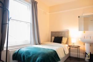 a bedroom with a bed with a large window at Spacious 10 Bed Contractor Pad in Bray