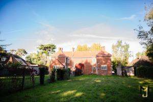 a large red brick house with a yard at Spacious 10 Bed Contractor Pad in Bray