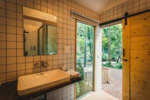 a bathroom with a sink and a sliding glass door at La Lanna in Ban Pok Nai +94 photos