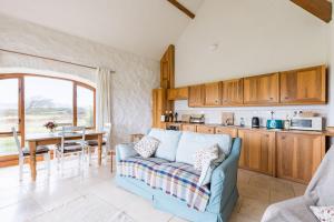 a living room with a couch and a table at Sunset in Goodwick