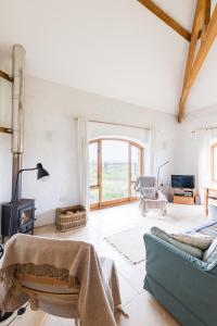a living room with a couch and a fireplace at Sunset in Goodwick
