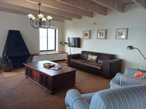 a living room with a couch and a coffee table at Whale Watch Cottage in St Helena Bay
