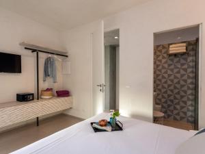 a bedroom with a white bed with a tv at VILLA MANDORLO 4, Emma Villas in Ragusa +20 photos