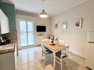 a kitchen and dining room with a table and chairs at Anna Luxury Apartment in Bisceglie
