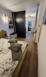 a bedroom with a bed with pillows on it at For You Apartments Silence in Sibiu