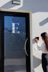 a woman taking a picture of a sign on a building at Essentia Rooms & Relax in Vasto