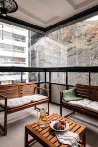 a room with benches and a table with a plate of food at Stylish Waterfront Apt Stockholm in Stockholm