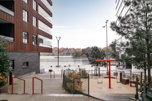 a park with a playground in front of a building at Stylish Waterfront Apt Stockholm in Stockholm