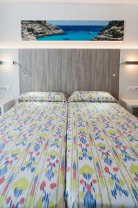 A bed or beds in a room at Hotel Amic Can Pastilla
