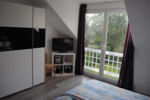 a bedroom with a bed and a large window at Villa Donar in Cologne