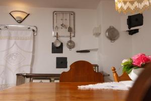 a dining room with a table and utensils on the wall at Ferienhaus im Gässle, Kirchzarten, Dreisamtal in Kirchzarten