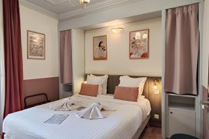 a hotel room with a bed with a robe on it at Aparthotel AMMI Vieux Nice in Nice
