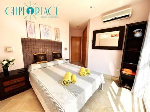 two beds in a bedroom with yellow pillows on them at Kenya 1ª Linea in Ifach +38 photos