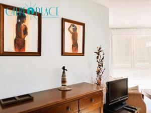 a living room with a tv on a wooden dresser at Kenya 1ª Linea in Ifach