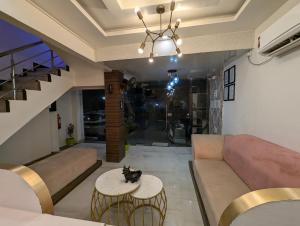 a living room with a couch and a table at The Vibs International in Damoh