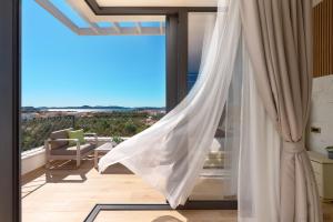 a room with a view of a balcony with curtains at Villa Liliana Vodice in Vodice +46 photos
