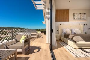 a bedroom with a bed and a balcony at Villa Liliana Vodice in Vodice