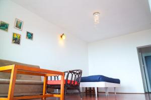 a living room with two chairs and a couch at HappyHuts at Green valley view in Kodaikānāl