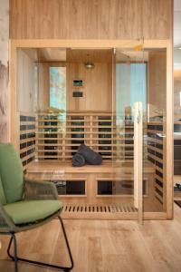 a room with a green chair and a glass wall at Villa Liliana Vodice in Vodice