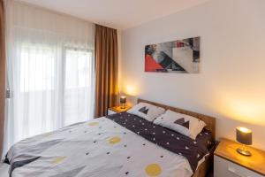 a bedroom with a bed and a window at Relax in Vranje
