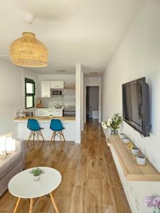 a living room with a couch and a table at Canaima 112 Puerto Rico in Puerto Rico de Gran Canaria