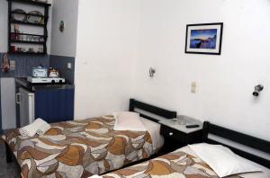 a hotel room with two beds in a room at Rooms Mike Paros in Kampos Paros