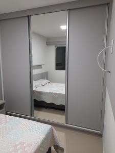 a reflection of a bedroom with a bed in a mirror at Parque veredas resort in Rio Quente