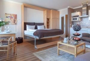 a bedroom with a bed and a living room at Vik1_17 in Westerland (Sylt) +14 photos