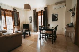 a living room with a table and chairs and a couch at La Fonda del Arco in Guadix